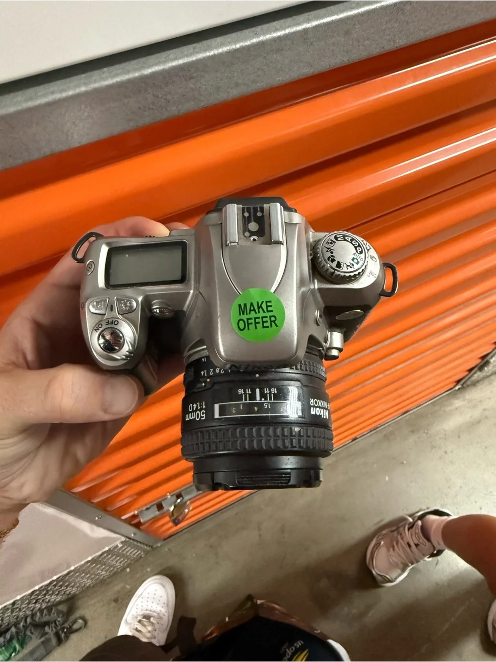 Nikon Silver and Black DSLR Camera with Nikon Lens Cap